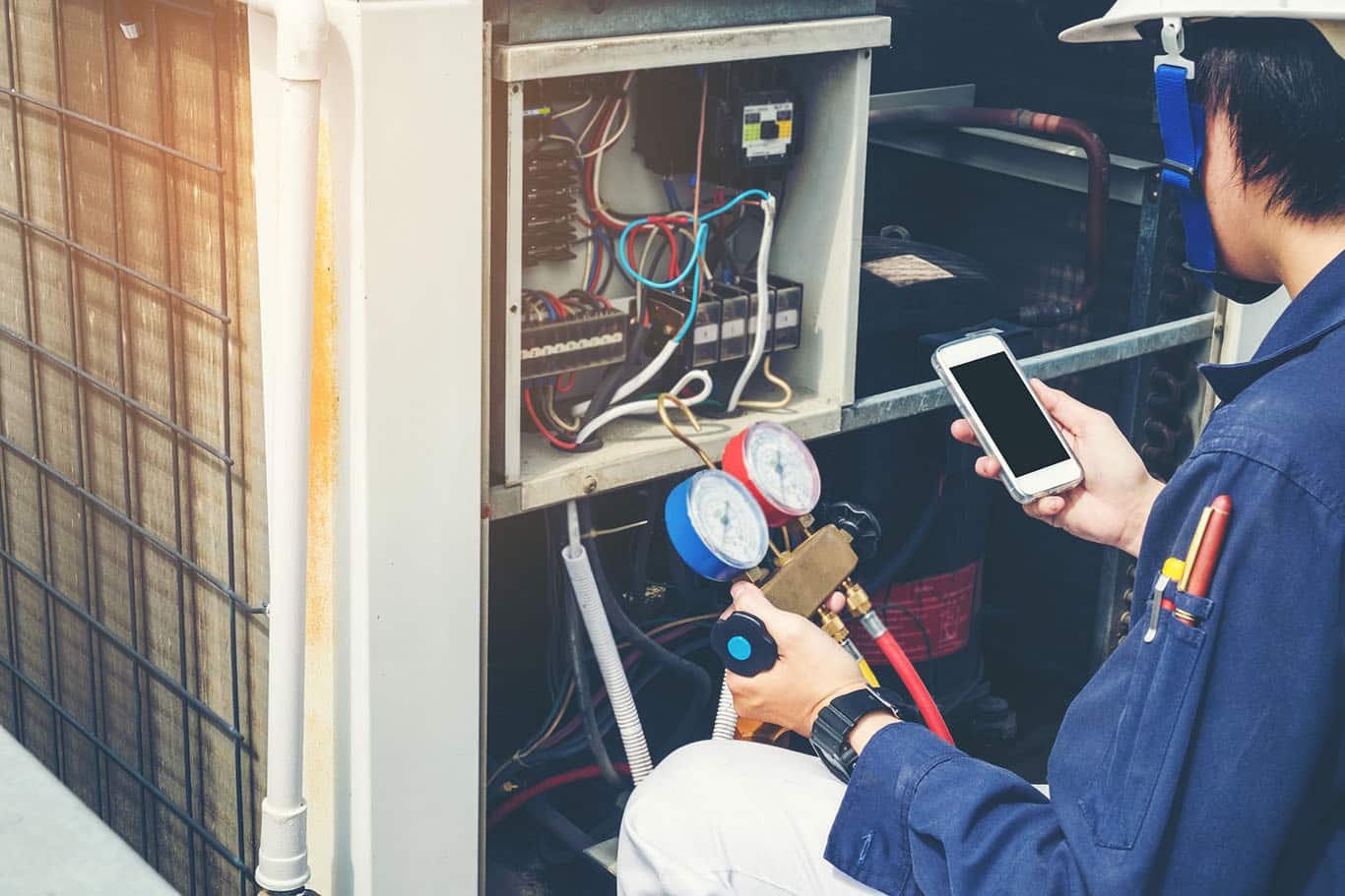 technician inspecting HVAC system