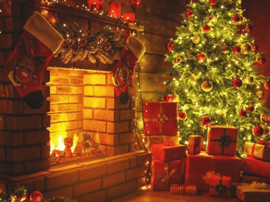 christmas tree next to a fireplace and presents